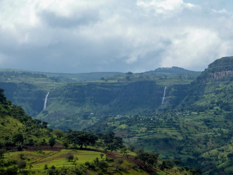 Waterfalls cascading over lush green cliffs in the mountains of Ethiopia