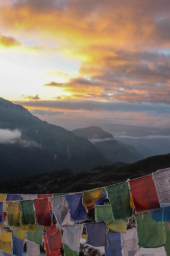 Frozen prayer flags on a mountain top in Sikkim at sunrise