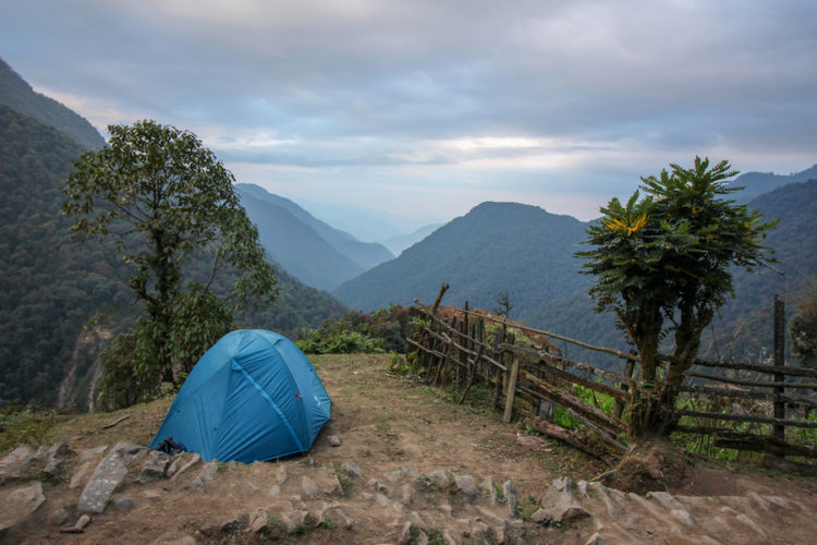 My blue tent pitched next to a trekking trail in Sikkim