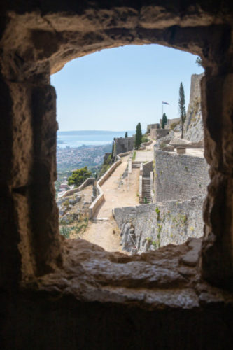 View-through-a-window-in-klis-fortress-towards-split-and-the-sea