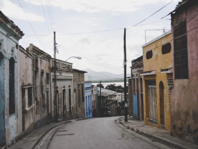 Typical street in Santiago de Cuba with old run down buildings