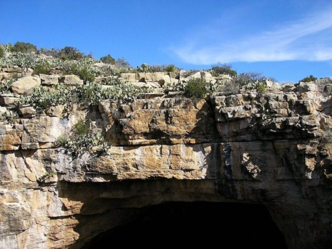 The Natural Entrance to carlsbad caverns with blue sky above