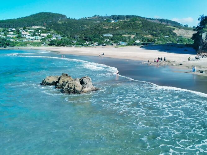 Coastline of the Coromandel Peninsula with clear sea and a picturesque beach