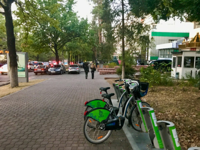 Green Almaty Bike city bikes on a sidewalk in Almaty