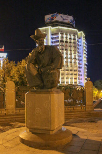 Sculpture of a man wearing traditional Kazakh clothes in downtown Almaty