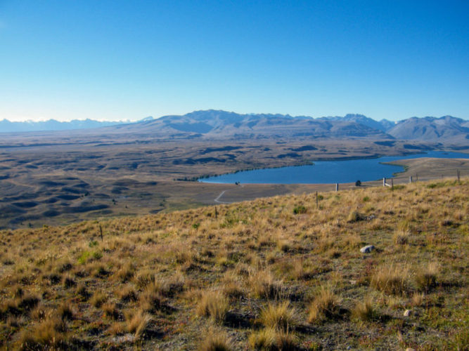 View-of-the-wilderness-with-grasslands-a-lake-and-mountains-in-the-distance-from-the-St-John-Observatory-at-Lake-Tekapo