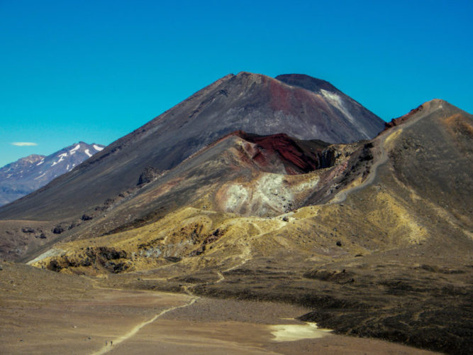 The Tongariro Alpine Crossing hiking trail crossing a mountainous volcanic landscape
