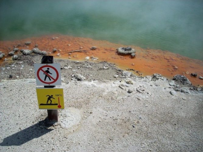 Warning sign on the edge of the boiling hot geothermal pools in Rotorua