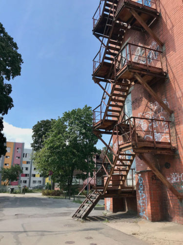 Photogenic old fire escape staircase running down the side of a building