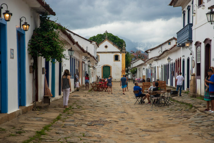 People sitting on chairs in the cobbled streets of Paraty