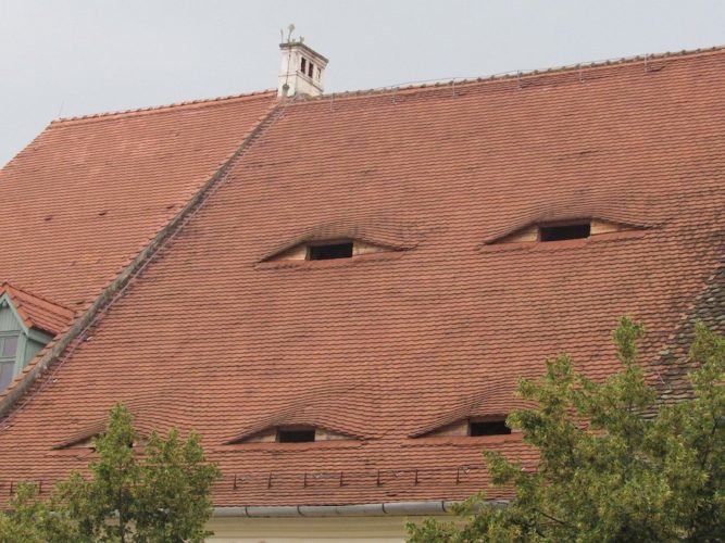 Rooftops in Sibiu with windows that look like eyes