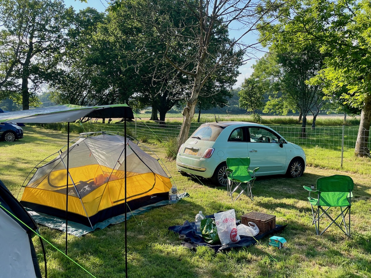 Yellow Forceatt 3 person tent inner tent pitched next to my green car in a field in Sussex