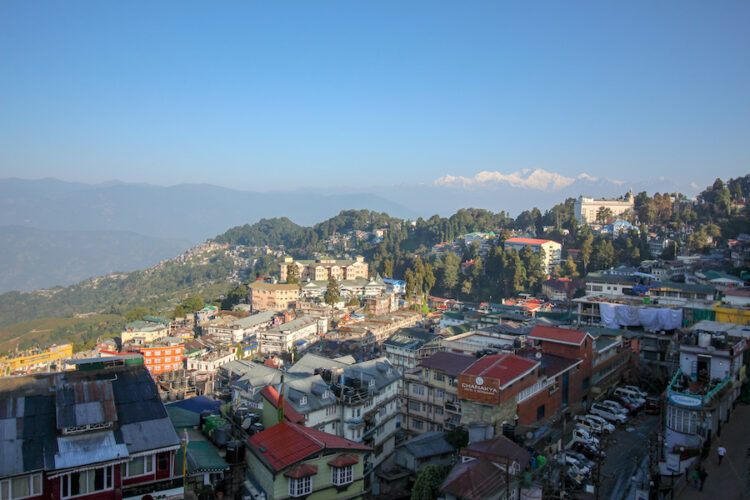 View over Darjeeling in the foothills of the Indian Himalayas with snow covered peaks in the distance