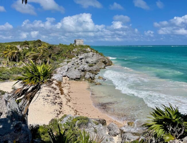Pretty beach with Mayan ruins on a headland overlooking the Caribbean Sea in Tulum