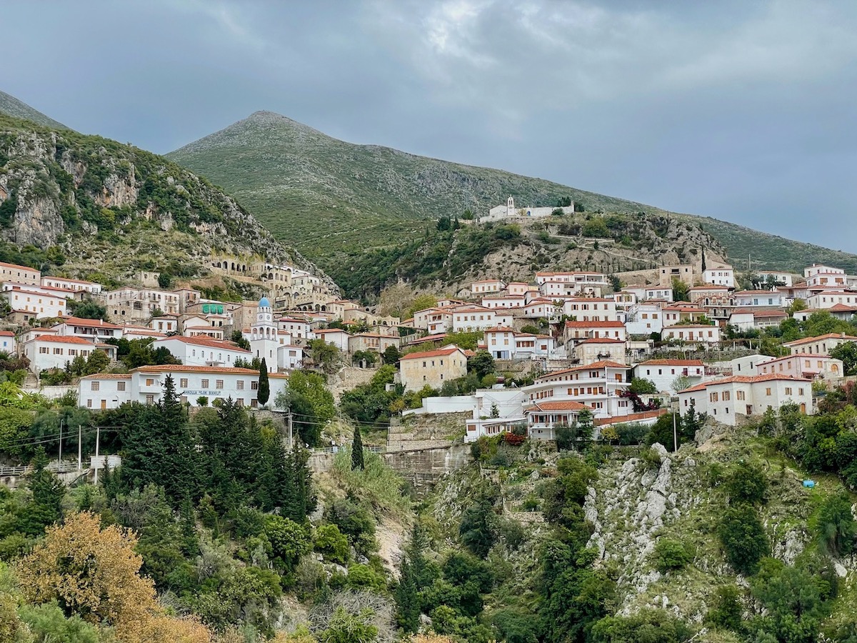 View of Dhermi village on a green hillside in southern Albania