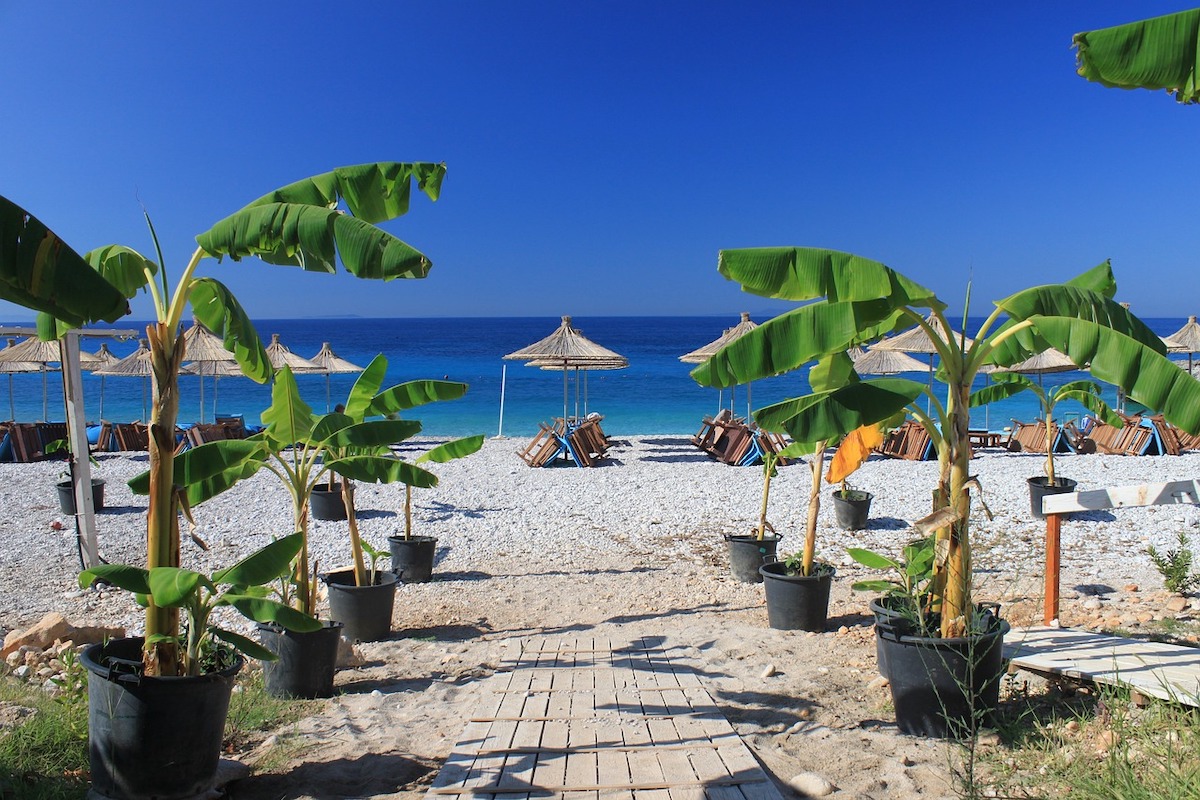 dhermi-beach-hotel-with-blue-sky-and-green-plants