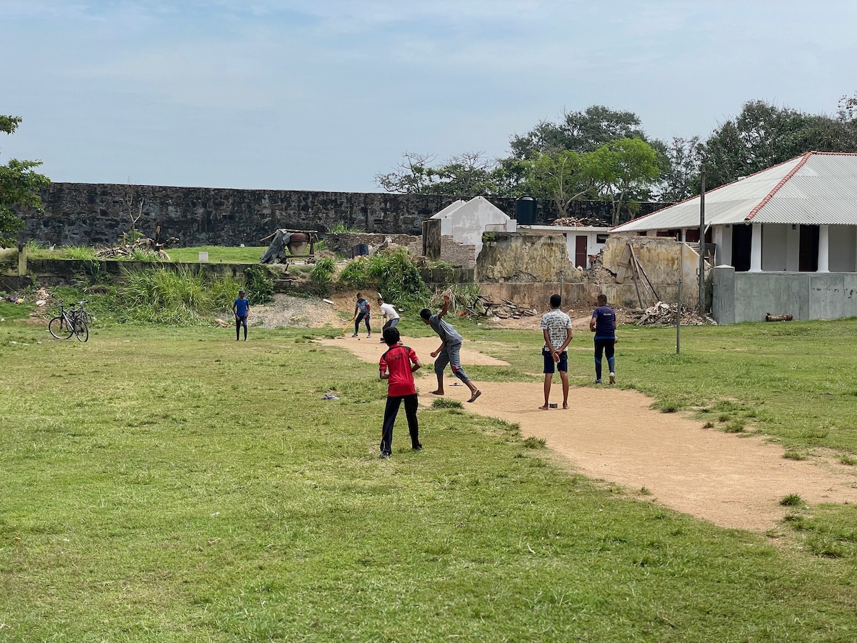 children playing cricket in galle fort