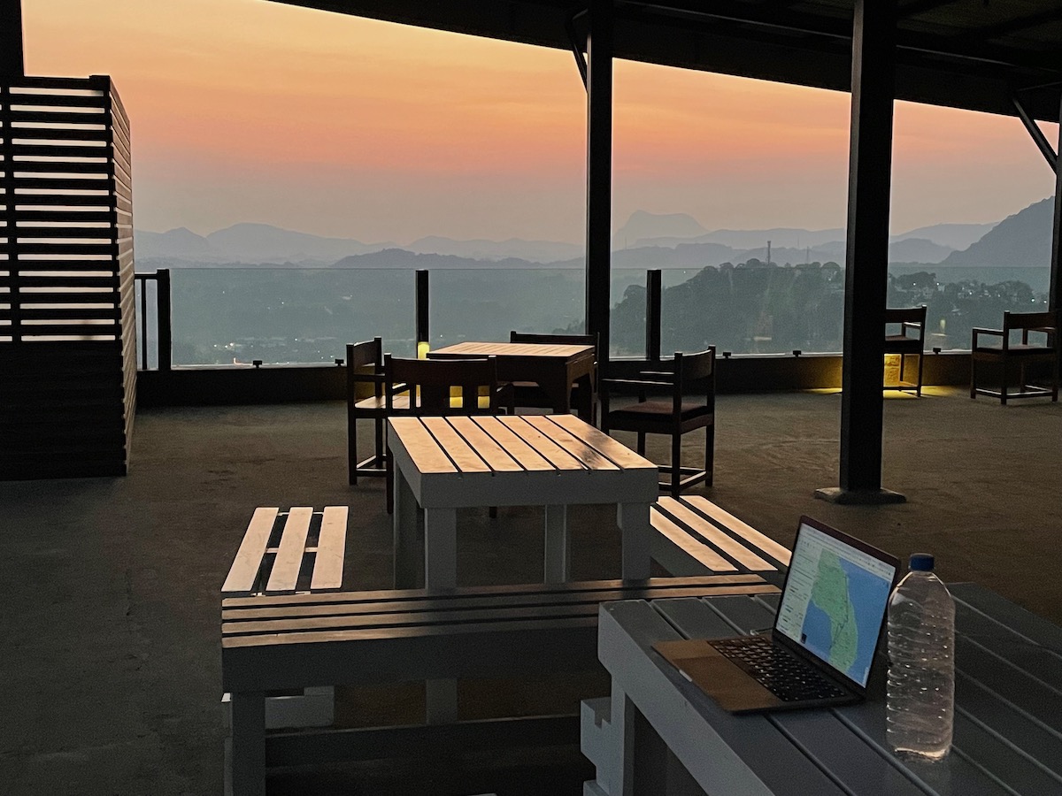 sunset-over-kandy-from-a-roof-terrace-with-benches-and-a-laptop
