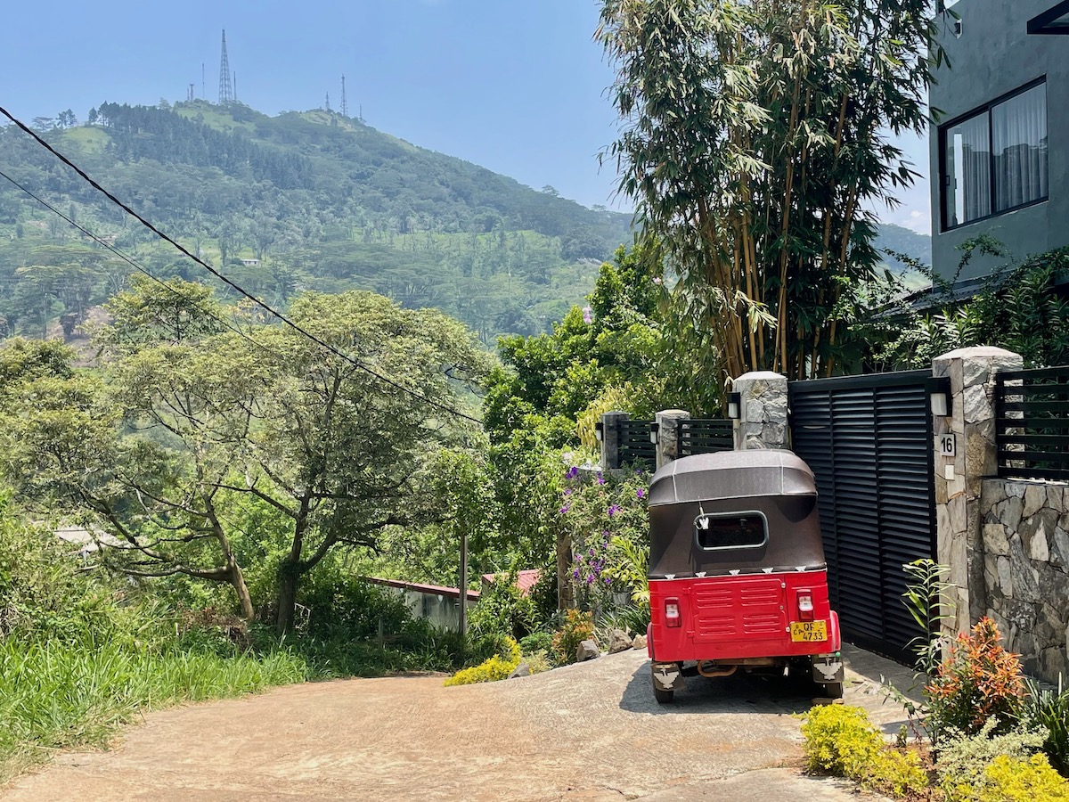 red-tuk-tuk-next-to-a-house-in-the-mountains-above-kandy