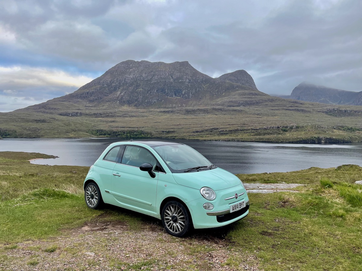 Green Fiat 500 in front of Loch Lurgainn in Assynt