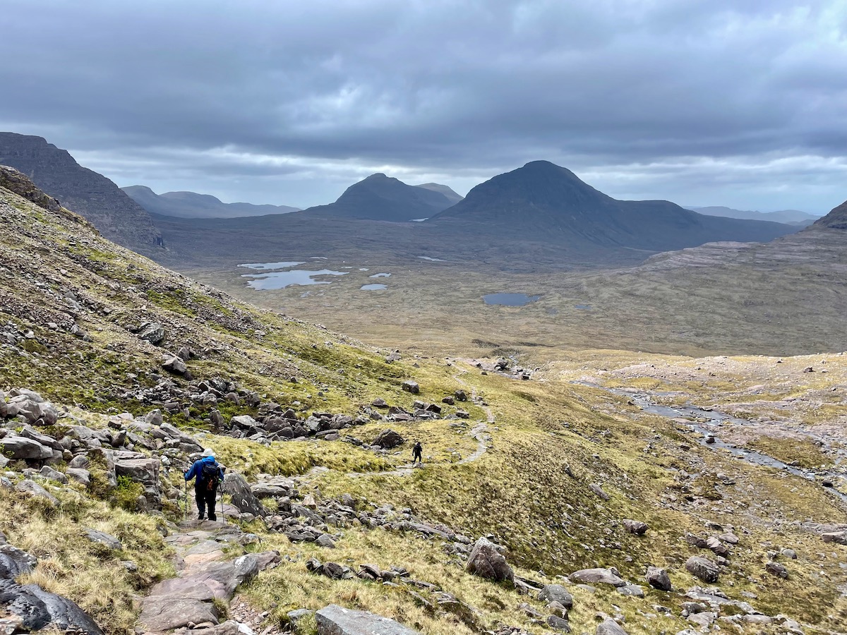 Hiking through the wilderness scenery of Torridon with a rough trail through the moorland