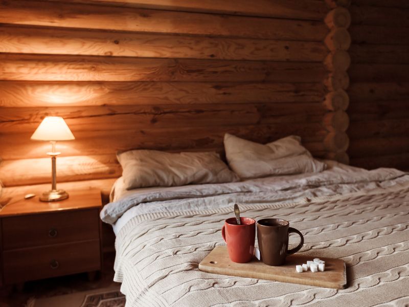 bed-inside-a-luxury-log-cabin-lodge-with-two-cups-of-tea