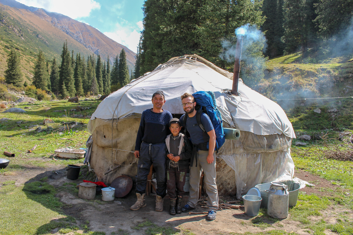alex-tiffany-with-family-of-nomads-outside-a-yurt-in-kyrgyzstan