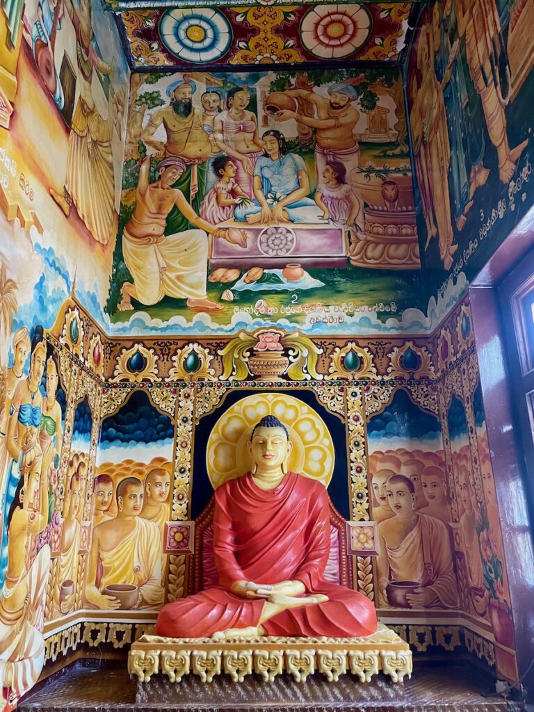 buddha-statue-with-colourful-murals-on-the-walls