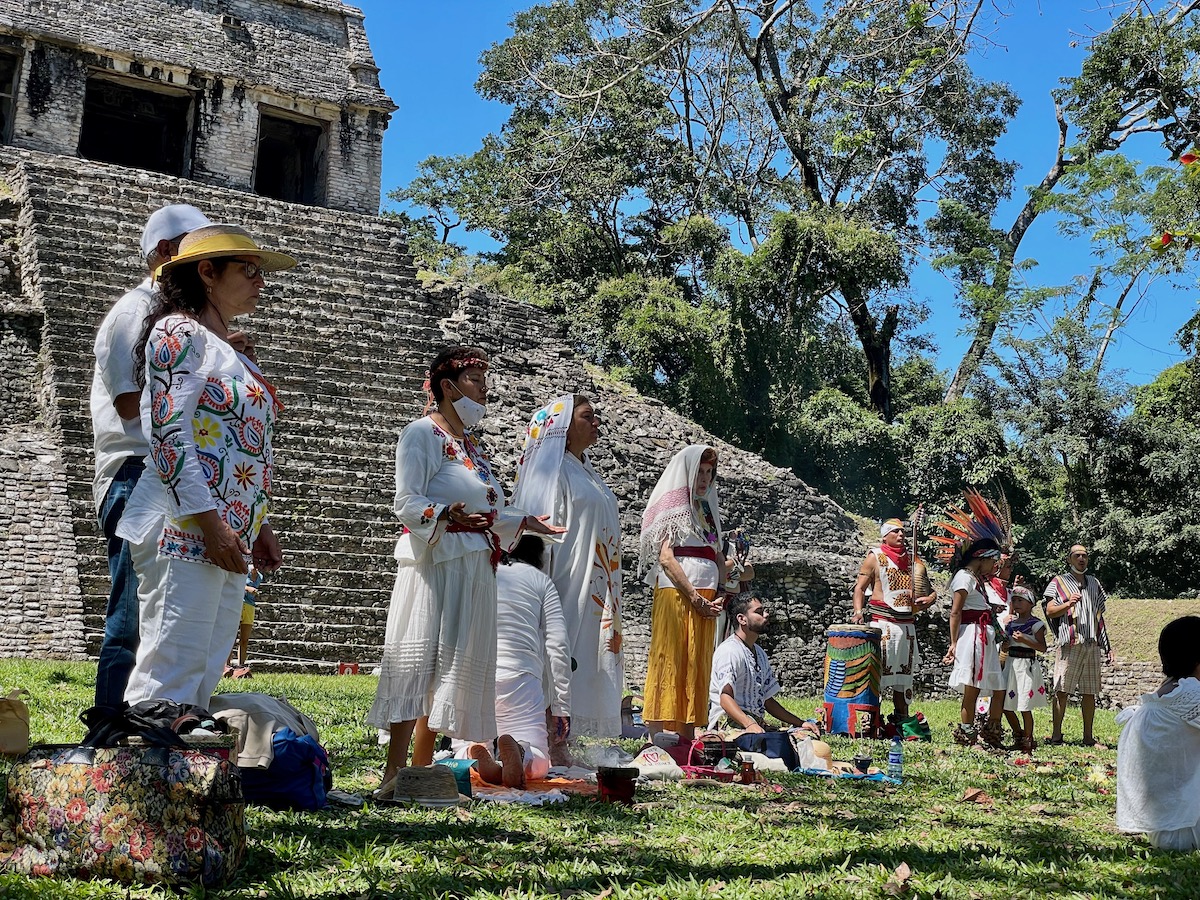 people dressed in white performing a pagan ritual at palenque in chiapas