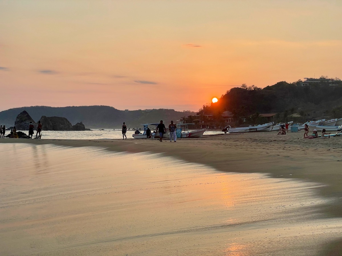 sunset reflected on playa san agustinillo beach on oaxaca coast