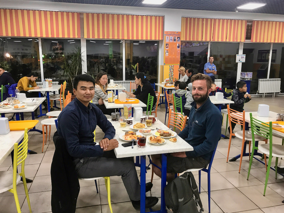 Alex Tiffany having dinner with a Kazakh friend in a restaurant in Almaty