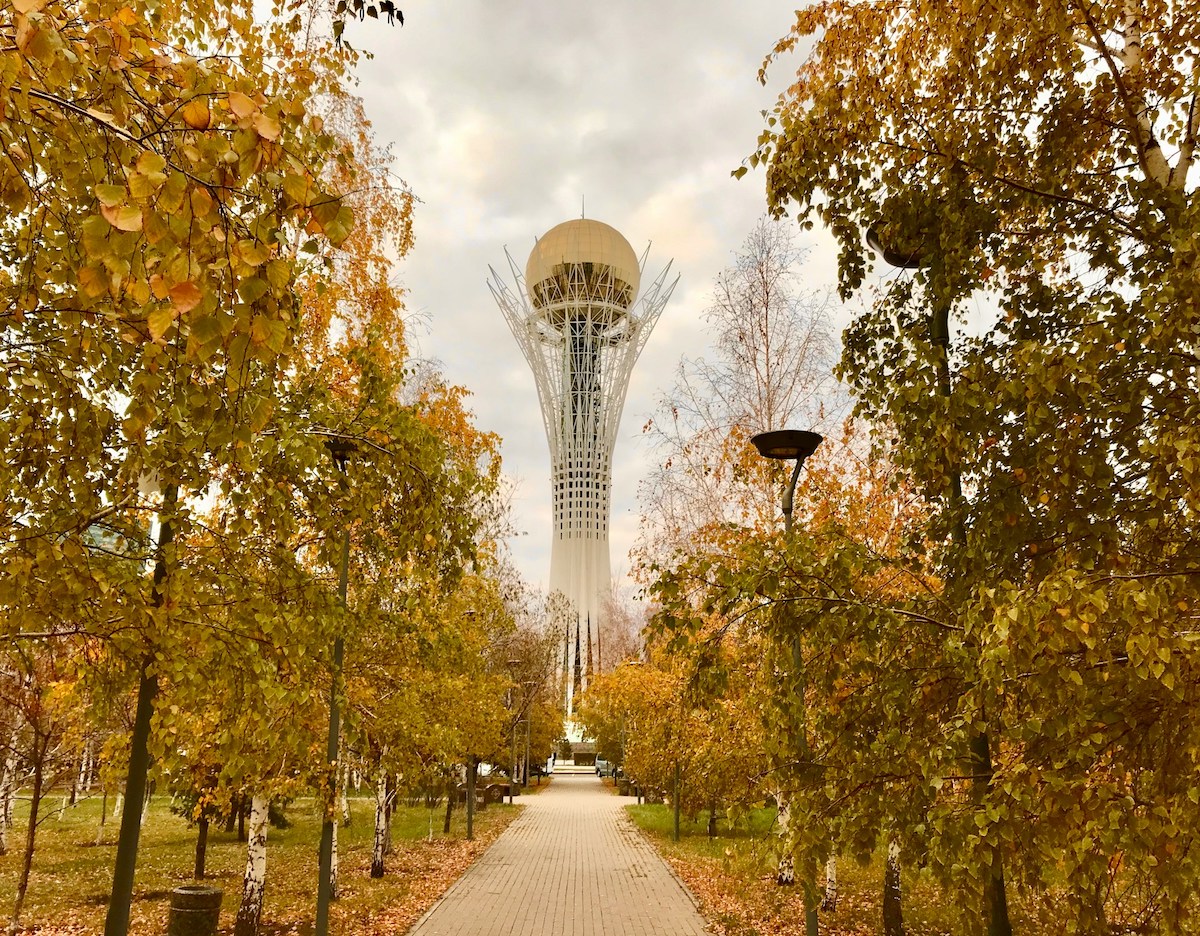 Baiterek-tower-in-nur-sultan-with-autumn-leaves-on-trees-in-foreground