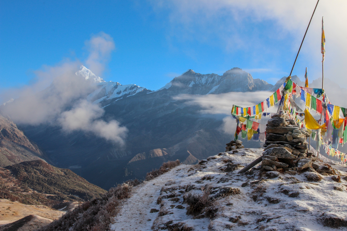 snowy mountains of the himalayas in sikkim with prayer flags