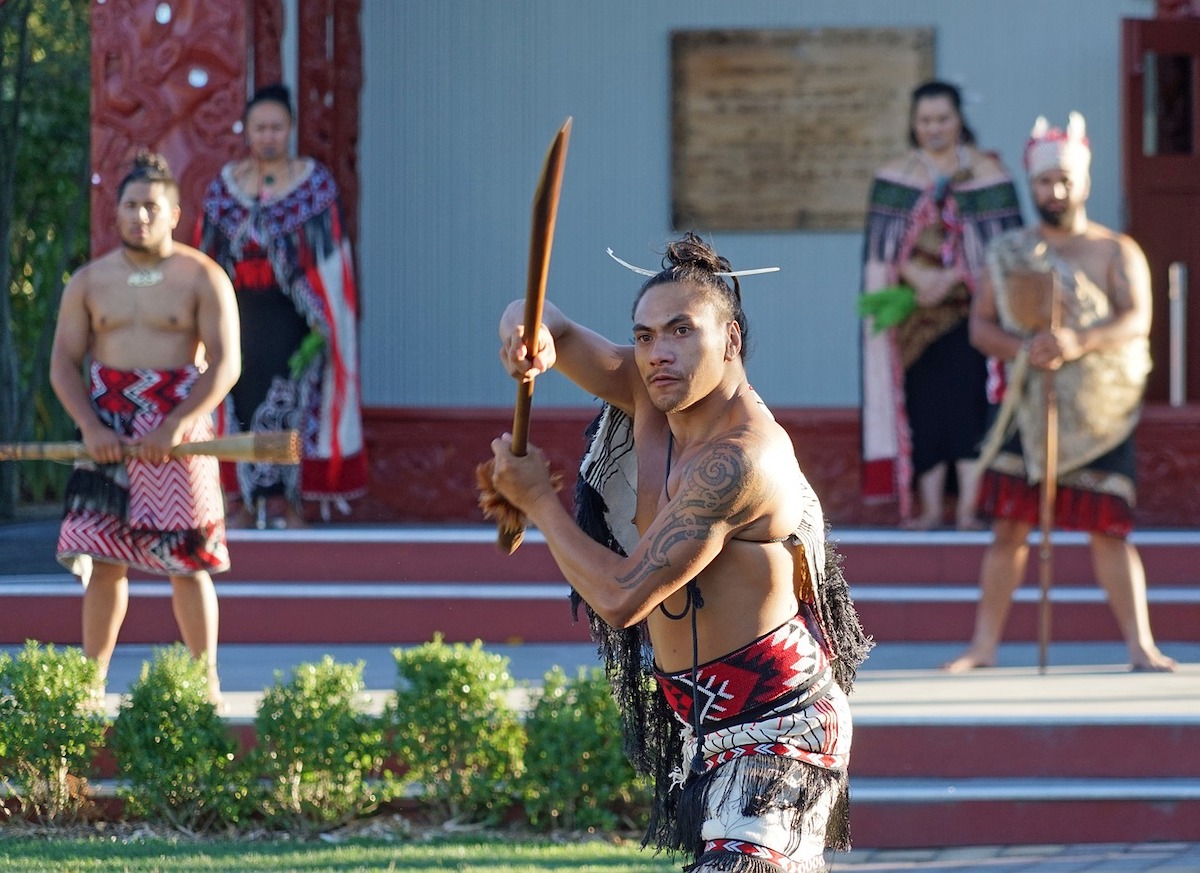 maori warriors in traditional dress performing