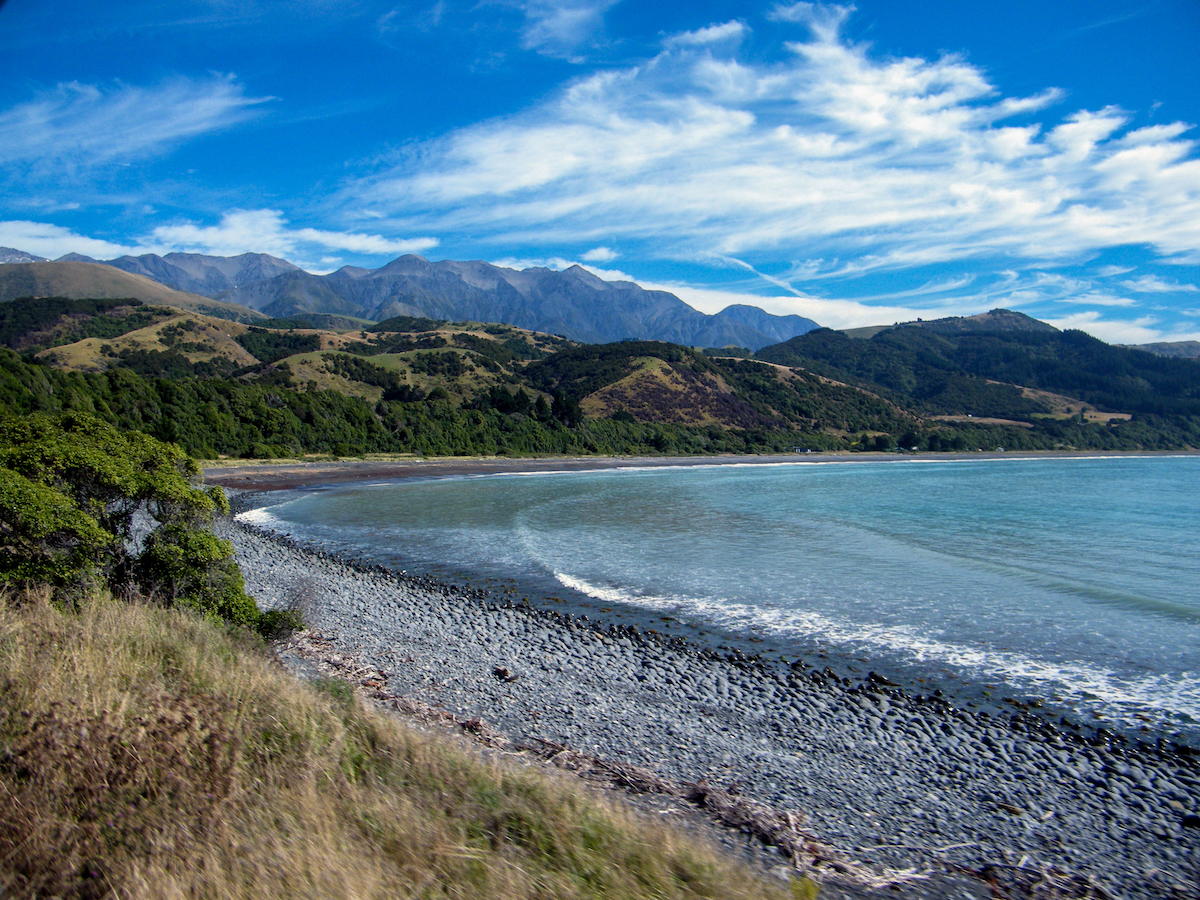 beach and bay near kaikoura new zealand with mountains and sea