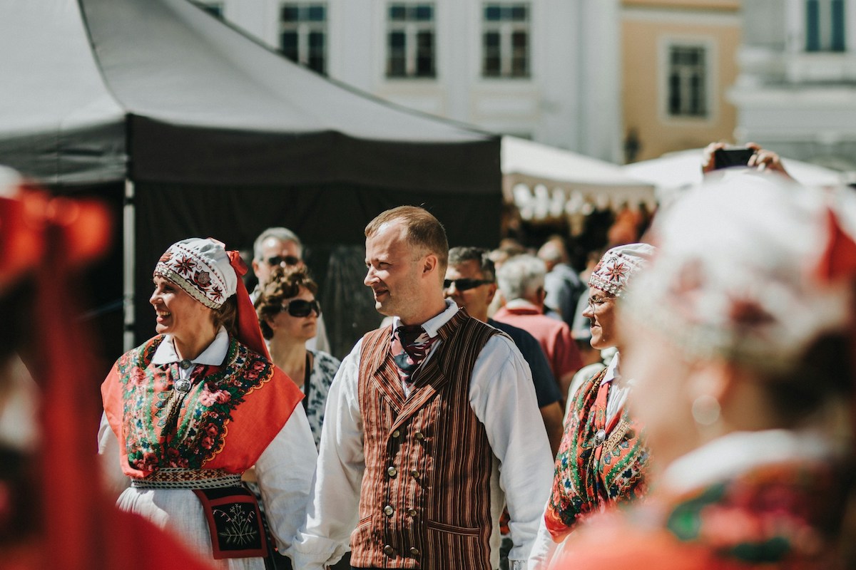 people in traditional folk costumes at a folk festival in estonia