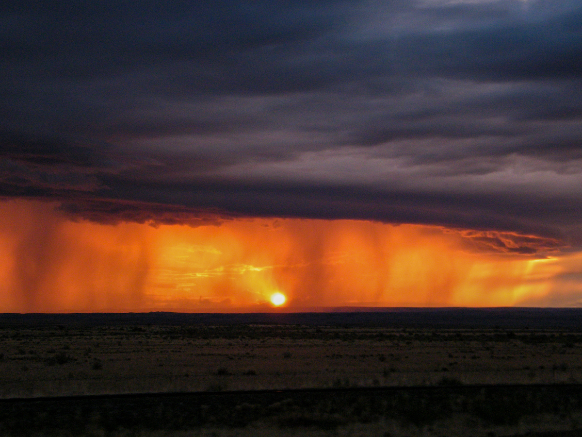 colourful thunder clouds and rain at sunset