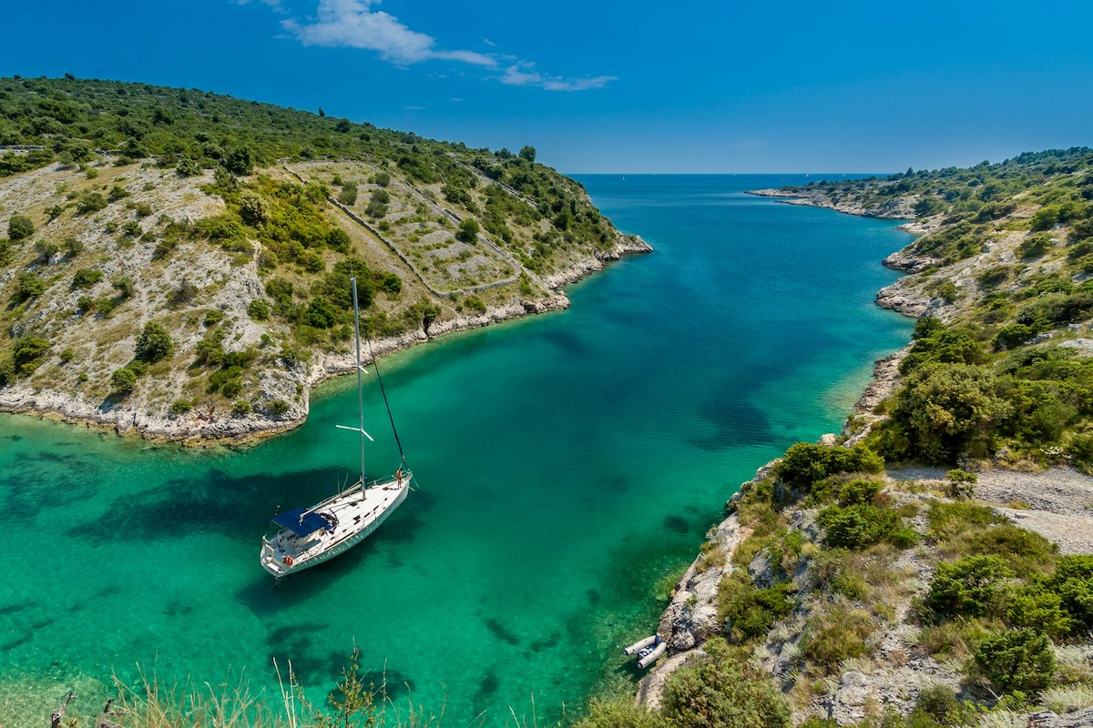 sailing boat navigating between croatian islands
