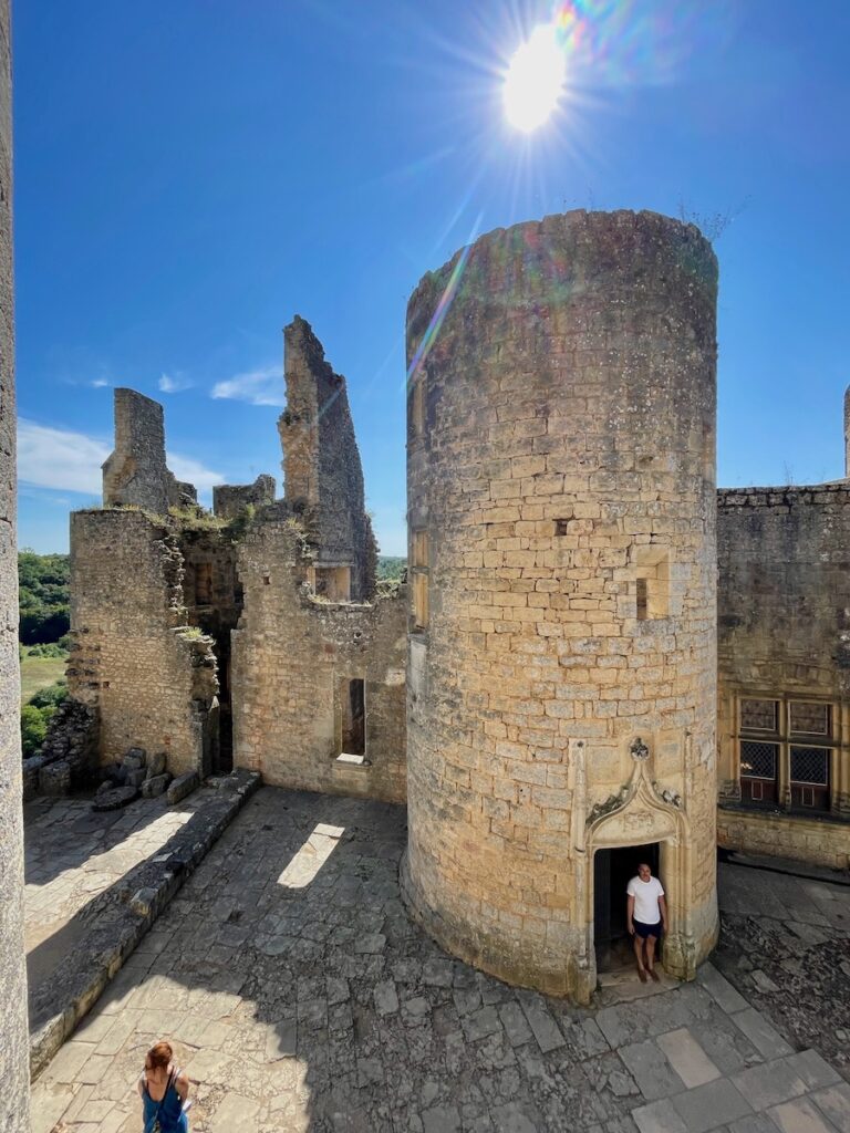 Man standing in the doorway of one of the towers of Bonaguil castle