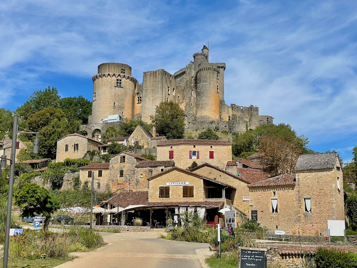 Chateau de Bonaguil castle rising impressively from the little village below it