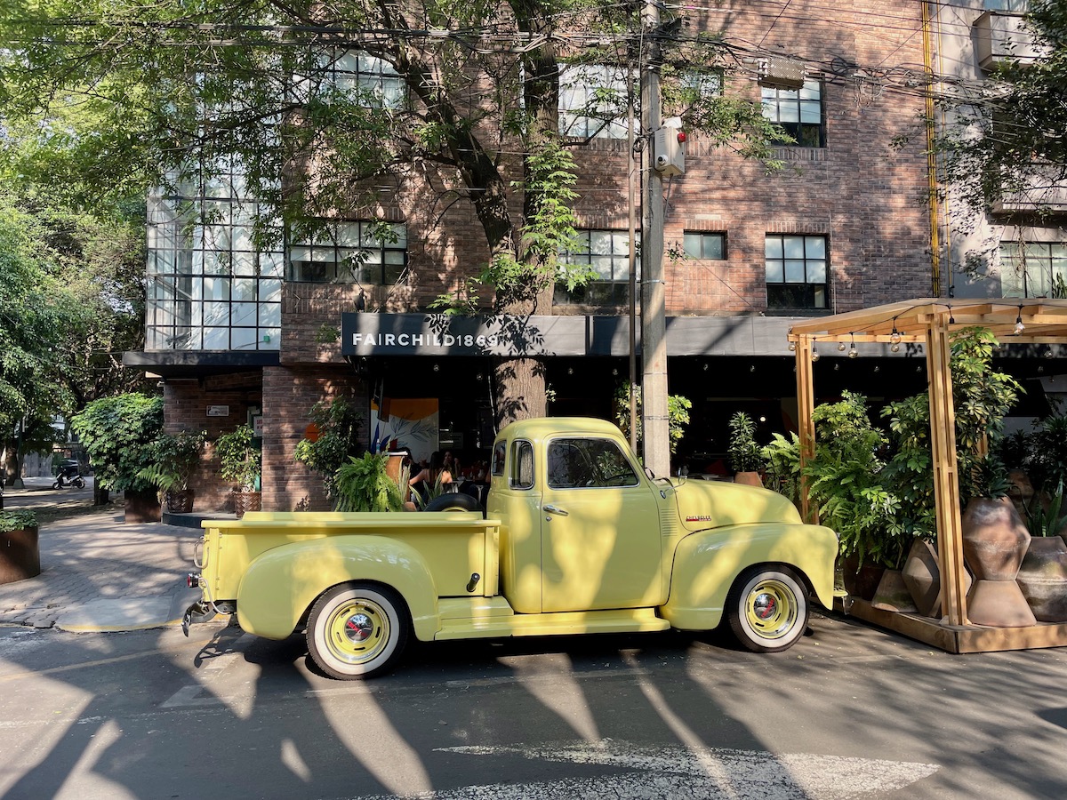 Yellow pickup truck parked outside a boutique hotel in polanco mexico city